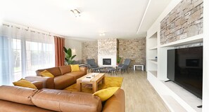 Cozy living space with a fireplace, comfortable seating area, and a dining space.
