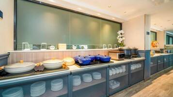 A buffet setup with various dishes and containers.