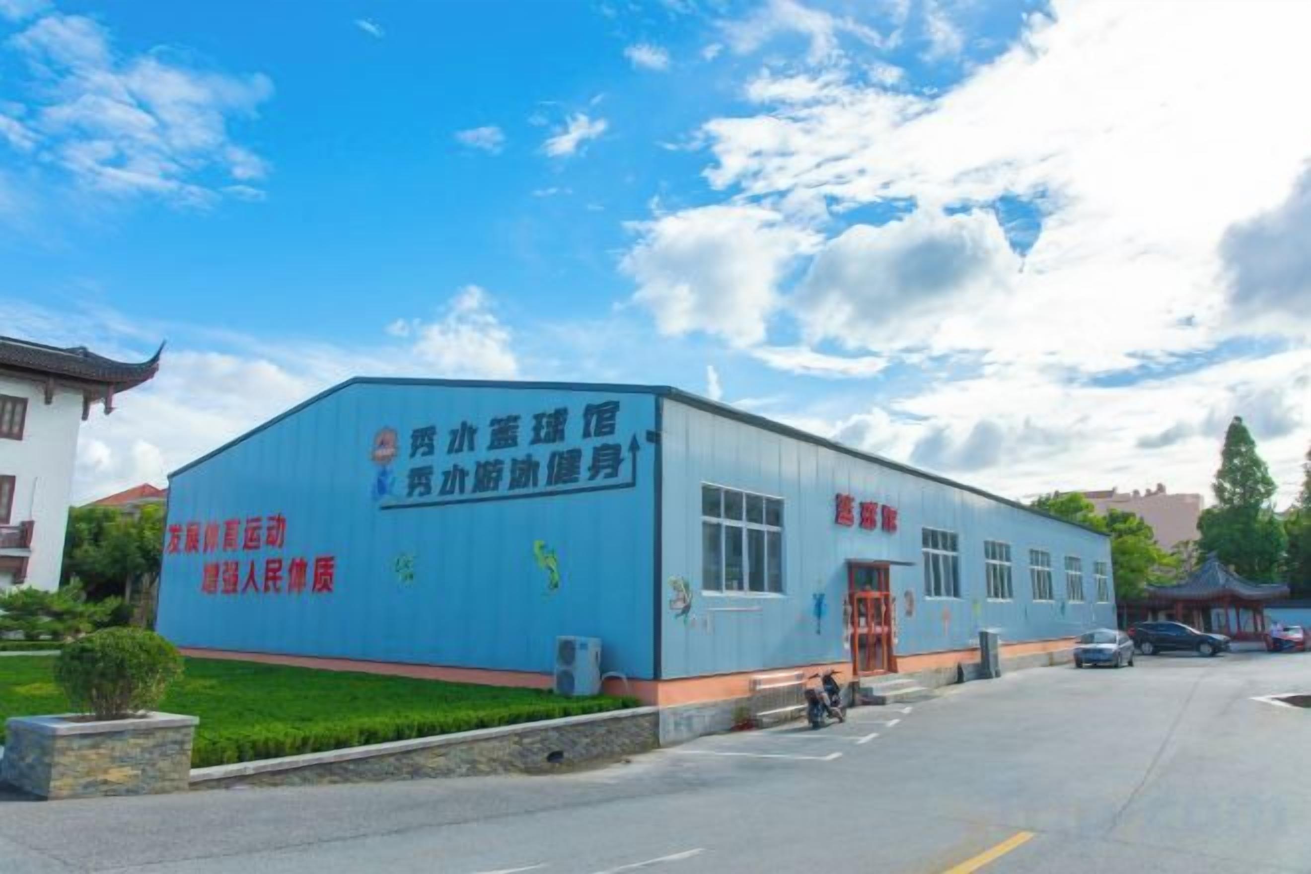 A blue industrial building with signage indicating it is a health and fitness center.