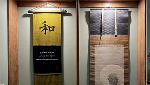 A traditional Japanese room with tatami flooring, a shoji screen, a hanging scroll with calligraphy, a small lantern, and a sake set. - Sakura – Calm, Cozy, & Close to Nature (Wentworth Falls)