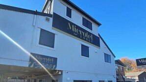 A two-story building with a sign reading "Microtel Lodge." - Microtel Lodge (Hamilton)