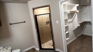 A bathroom with a toilet, a sink, and a shower area. - Cozy 3BR Home in Poolville / AC + Fast WiFi / Relaxing Escape (Poolville)