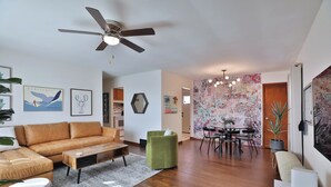 Un salon moderne comprenant un canapé, une table basse et un coin repas avec une table et des chaises.