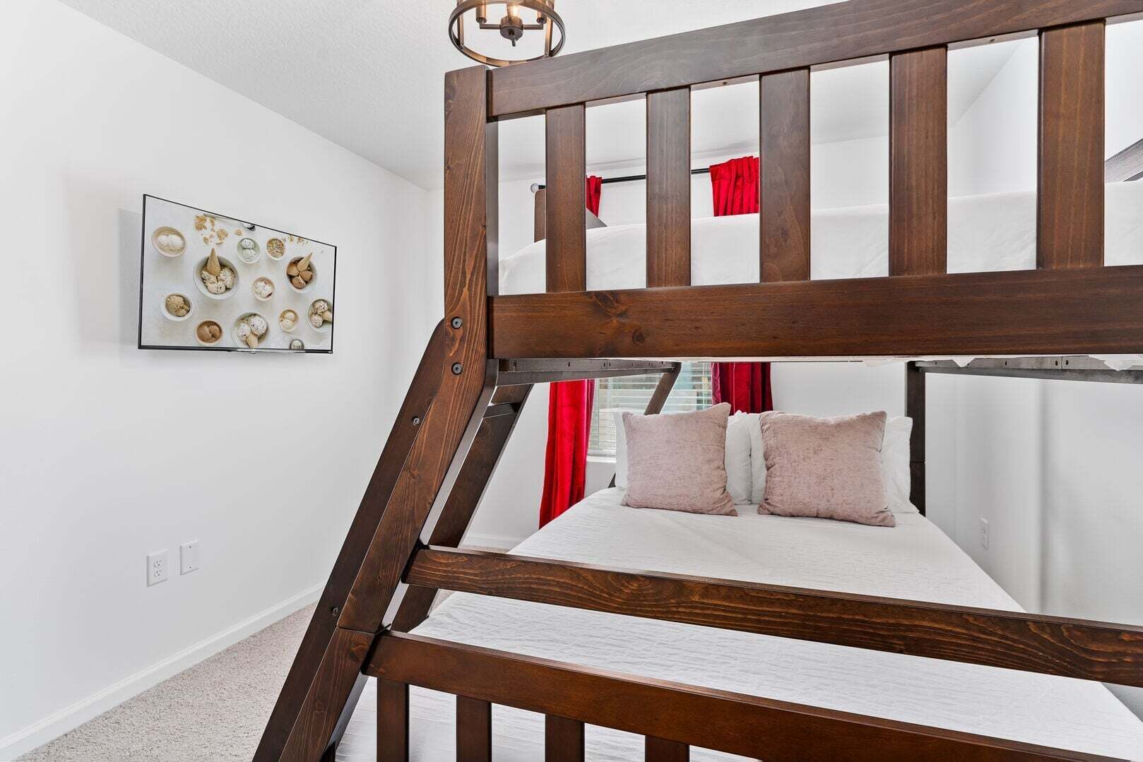 A bunk bed with a wooden frame, a white mattress, and two pillows.