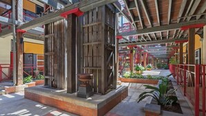 An outdoor area with a wooden structure, a fire pit, and potted plants. - Woolstore Style! ~ 2Bed/2Bath/1Car ~ Teneriffe (Teneriffe)
