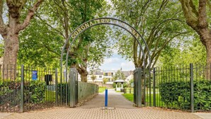 A gated entrance with a sign reading "CORONATION PARK". - Spacious Modern House 3BR 3BA Balcony Park View (London)