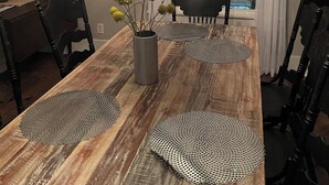 A dining room with a wooden table, black chairs, a chandelier, and a fireplace. - 3-bedroom duplex yellow house downtown  Des Moines with AC, WiFi (des moines)