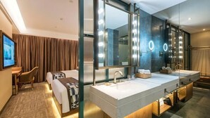 A modern hotel room with a large mirror, two sinks, a bed, a desk, and a television. - James Joyce Coffetel (Beijing South Railway Station Yongdingmenwai Subway Station) (Beijing)