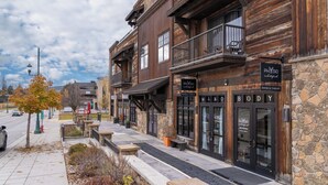 A row of wooden buildings with storefronts, including a physical therapy clinic. - Loft in heart of Downtown- Walk to City Beach, Dining & Shops! Modern Loft (Whitefish)