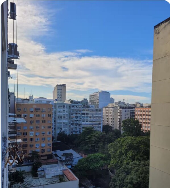 A cityscape with multiple high-rise buildings, some with balconies and air conditioning units.