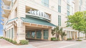 A hotel with a prominent 'OCEAN' sign, a covered entrance, and a number '3421' on the facade. - Charming 1-bedroom bed & breakfast resort in awesome Virginia Beach (Virginia Beach)