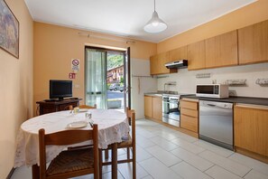A kitchen with wooden cabinets, a microwave, an oven, and a dishwasher.