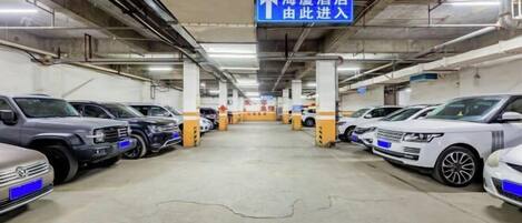 A multi-level parking garage with cars parked on both sides.