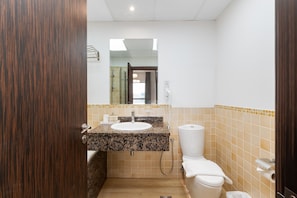 A bathroom with a sink, toilet, and shower.