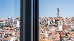 A cityscape with a prominent tower and densely packed buildings.