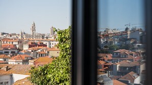 A cityscape with a prominent tower, dense residential buildings, and a clear sky.