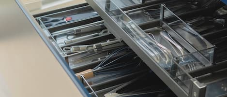 A kitchen drawer with utensils and cookware.