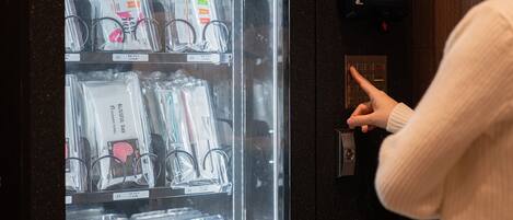 A person interacting with a self-service kiosk in a hotel.