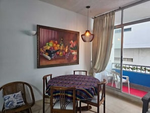 Enjoy meals in this dining area with a table for four, a large window, and a balcony with a view.