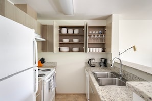 Enjoy cooking in this well-equipped kitchen with an oven, stovetop, and double sink.