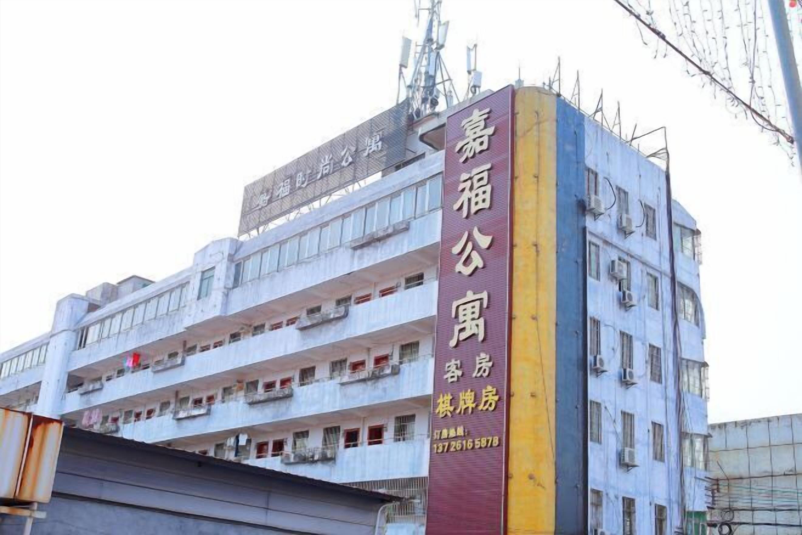 A multi-story building with a prominent vertical sign indicating it is a hotel.