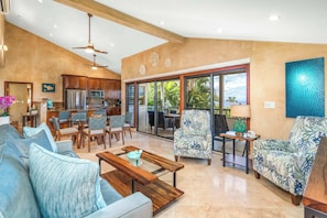 A spacious living area with a kitchen, dining area, and seating with a view.
