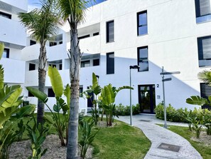 A modern building with a flat facade, multiple windows, and a central entrance. - El rincon de candor by staycare (Rota)