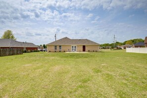 A single-story house with a front yard, a garage, and a small porch. - Patio & Spacious Yard: Home in Athens (Athens)