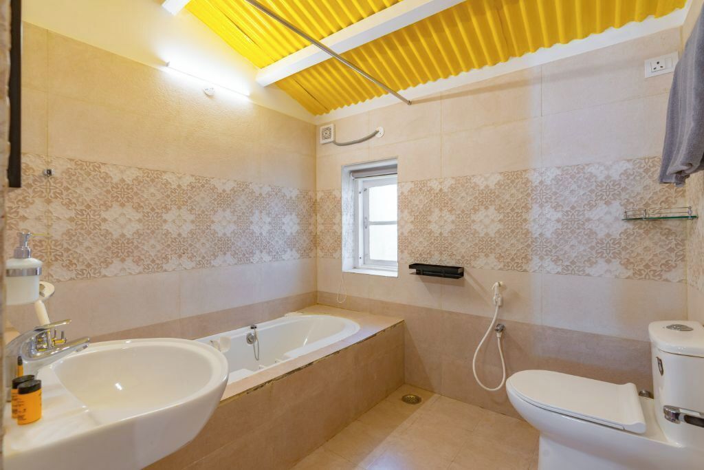 A bathroom with a bathtub, a sink, and a toilet.