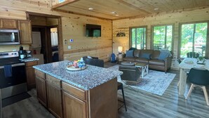 A spacious cabin with a large kitchen, dining area, and a balcony. - RiverBend Haven-Sleeps 8-River Access (Broken Bow)