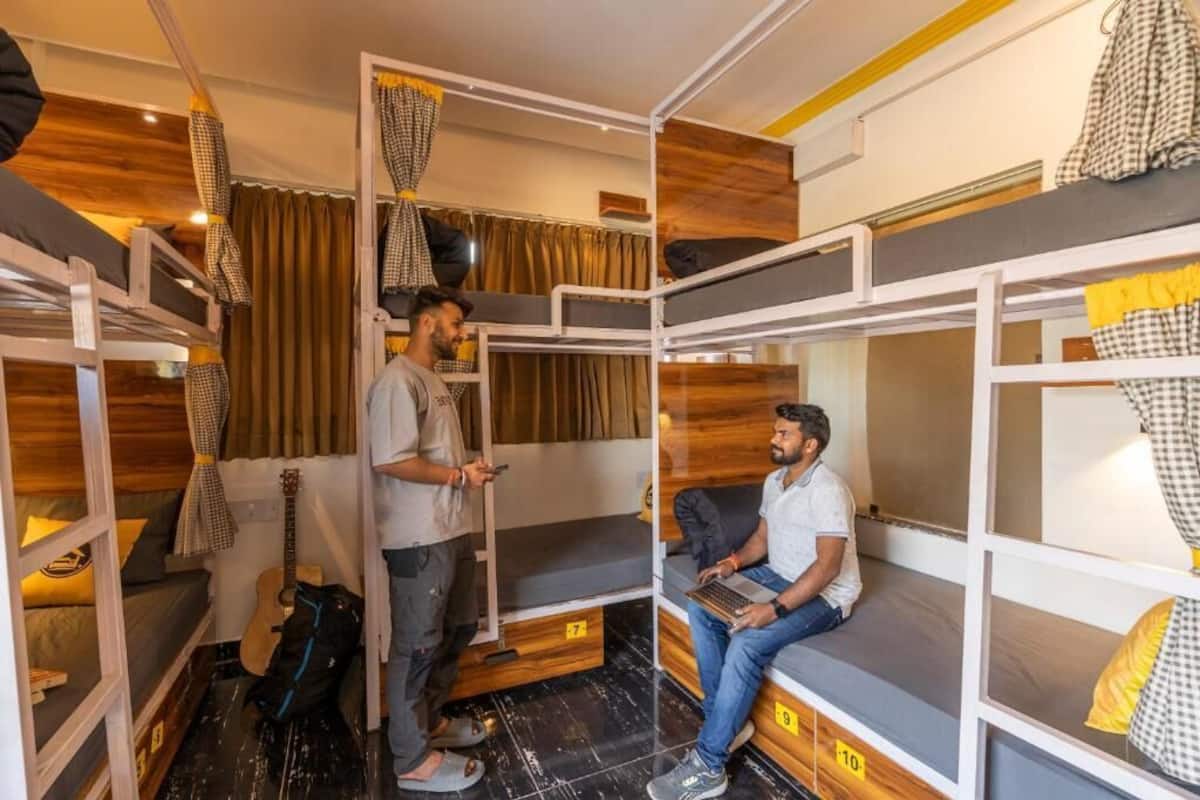A compact, bunk-style room with wooden accents and a guitar.