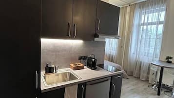 Fridge, microwave, coffee/tea maker, cookware/dishes/utensils