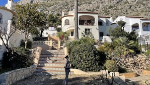 Una zona residencial en una ladera con una escalera que lleva a un edificio con balcones.