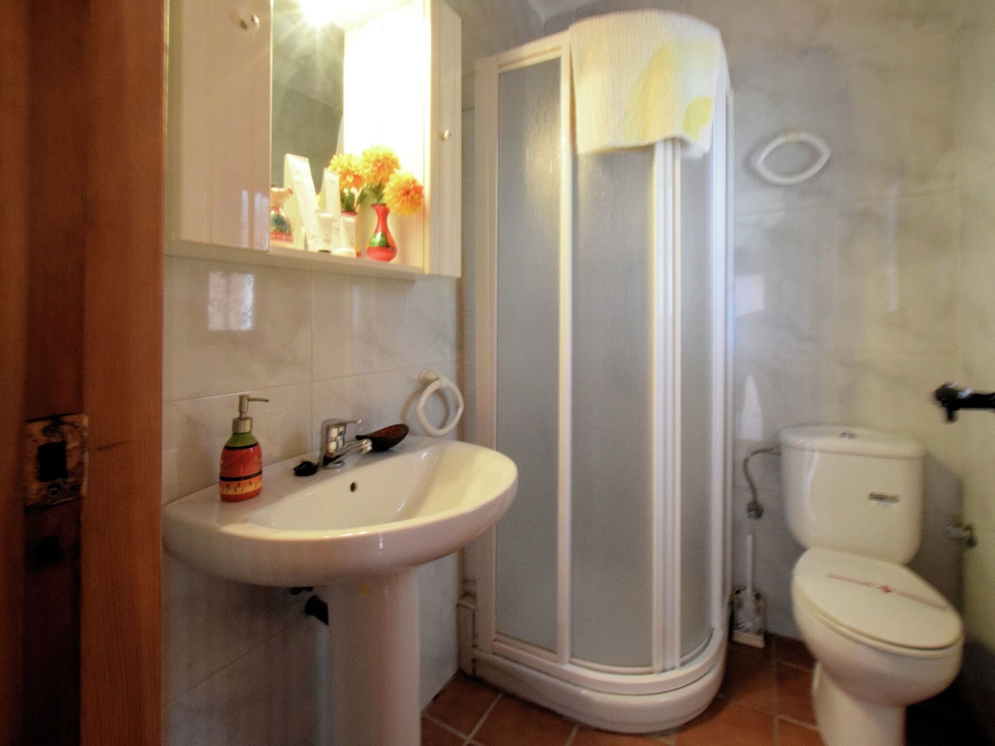 A bathroom with a sink, toilet, and shower.