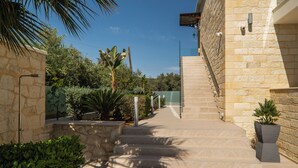 A stone staircase leading up to a building with a clear sky above. - Altirina Studios (Almyrida)