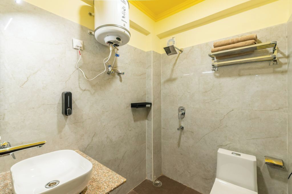 A bathroom with a shower, toilet, and sink.