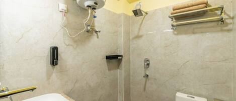 A bathroom with a shower, toilet, and sink.