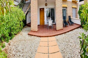 A building with a covered patio, a staircase, and a door. - Belvilla by OYO Apartamento VerandaMar Sandra (Almeria)