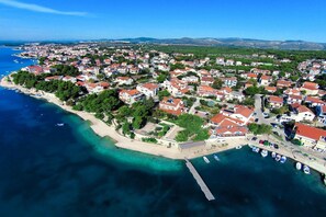 An aerial view of a coastal town with a marina, buildings, and a beach. - Apartment in Šibenik near Adriatic Beaches (Šibenik-Brodarica)