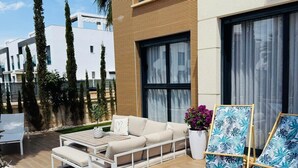 A modern outdoor patio with a sofa, coffee table, and lounge chairs. - Ground floor  La Zenia beach, Orihuela Costa (La Zenia)
