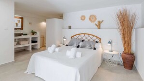 A neatly arranged bedroom with a bed, bedside tables, and a potted plant. - Scenic Villa, Costa Blanca (Denia)