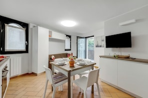 Enjoy meals in the dining area with a flat-screen TV and comfortable seating.