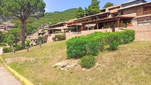 A hillside hotel with terraced structures, outdoor seating areas, and a clear view of the surrounding landscape. - Apartment in Olbia with Private Terrace (Olbia)