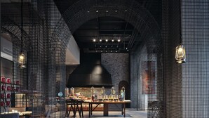 An interior with a central table, chairs, and a kitchen area. - WANDA REALM Yan'an (Yan'an)