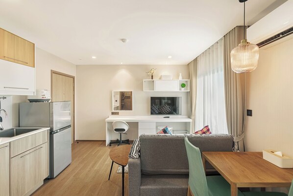 Relax and work in style with a spacious living area, kitchenette, and dedicated workspace.