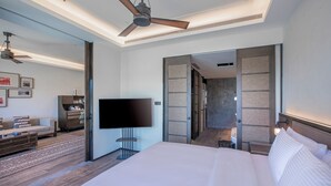 A modern hotel room with a large bed, a flat-screen TV, a ceiling fan, and a walk-in closet. - WANDA JIN Yan'an (Yan'an)