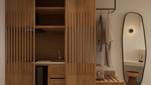 A modern bedroom with a wooden wardrobe, a built-in desk, and a mirror. - néreya luxury rooms (Rhodes)