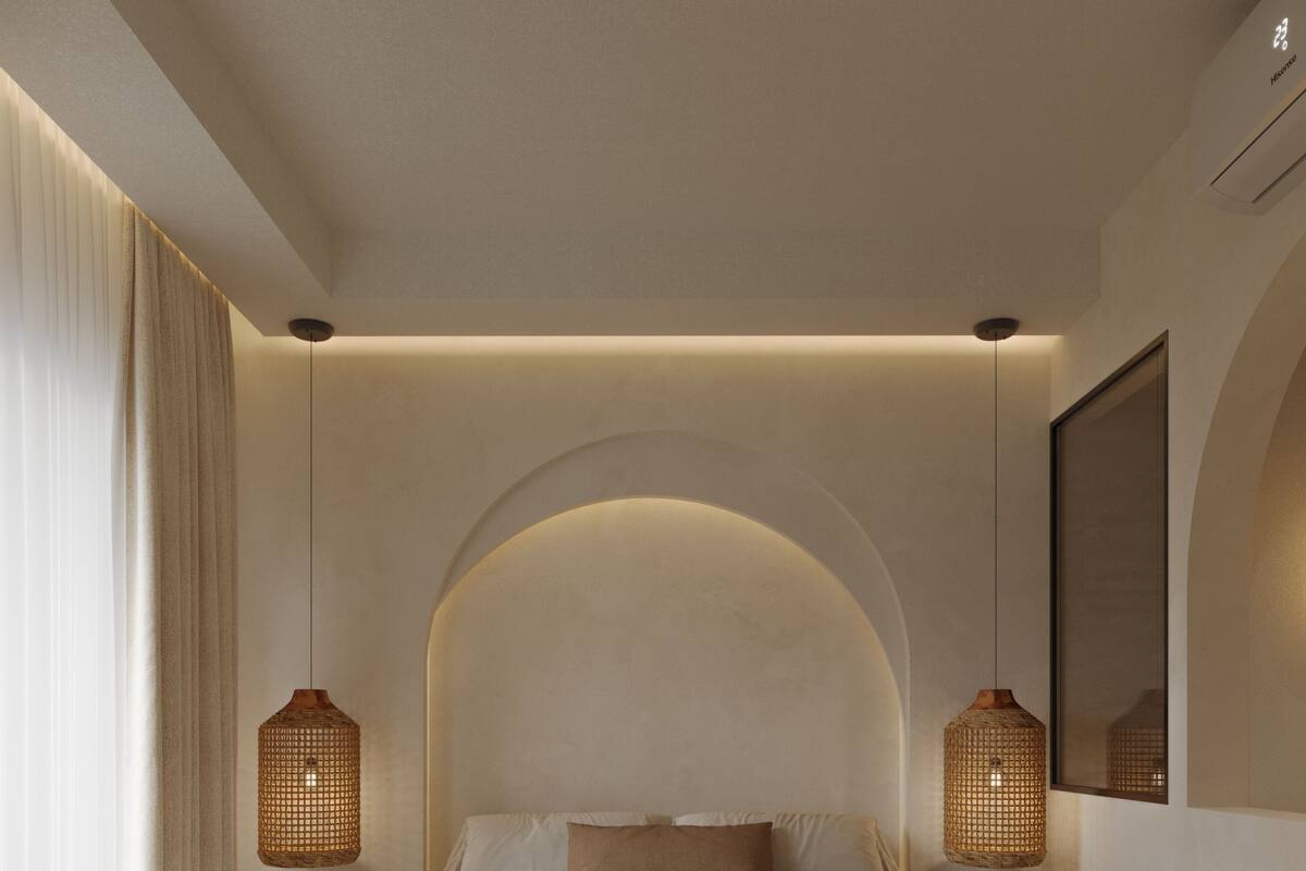 A modern bedroom with a large bed, two wall-mounted lamps, and a large mirror.