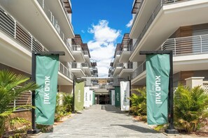 A corridor with multiple floors of residential buildings, each with balconies and a clear sky above. - Red Canyon Spa Cozy Stay by Sea N' Rent (Eilat)