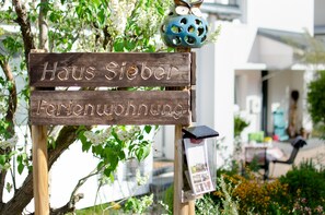 A wooden sign with 'Haus Sieber Ferienwohnung' indicating a vacation rental property. - Holiday Apartment 'Sieber' with Shared Pool, Private Terrace and Wi-Fi (Schiltach)